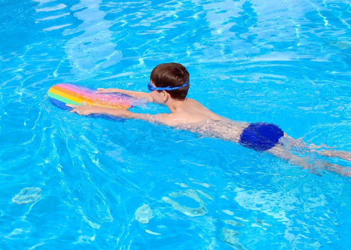 Picture of boy swimming in an outdoor swimming pool
