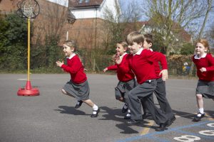 Children undertaking physical activity in a school playground